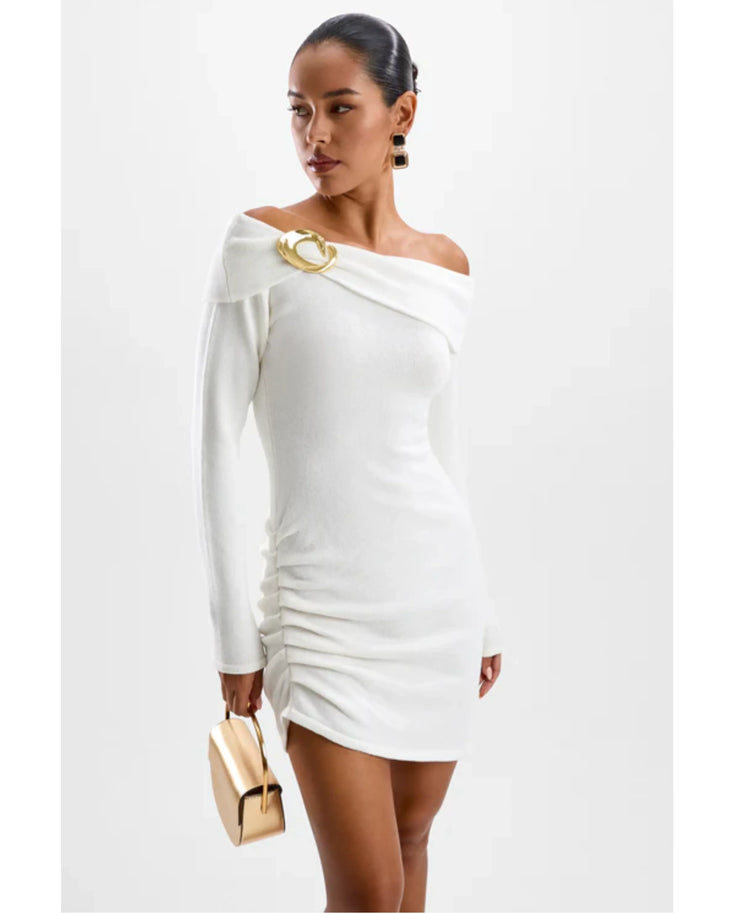 Woman in white off-shoulder long-sleeve knit dress with gold accents and matching accessories — Cin Cin | Endless UAE