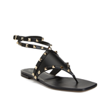 Black leather thong sandals with gold pyramid studs and ankle wrap strap — Valentino Garavani | Endless UAE