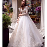 Elegant white wedding dress with beaded lace bodice and flowing ball gown skirt — Mar©a Anette | Endless UAE