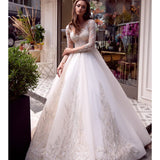 Elegant white wedding dress with beaded lace bodice and flowing ball gown skirt — Mar©a Anette | Endless UAE