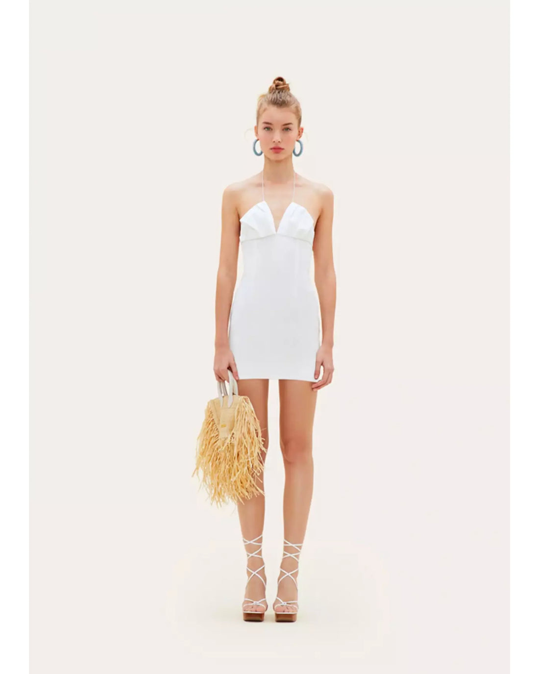 White strapless mini dress with plunging neckline styled with raffia bag and lace-up sandals — Jacquemus | Endless UAE