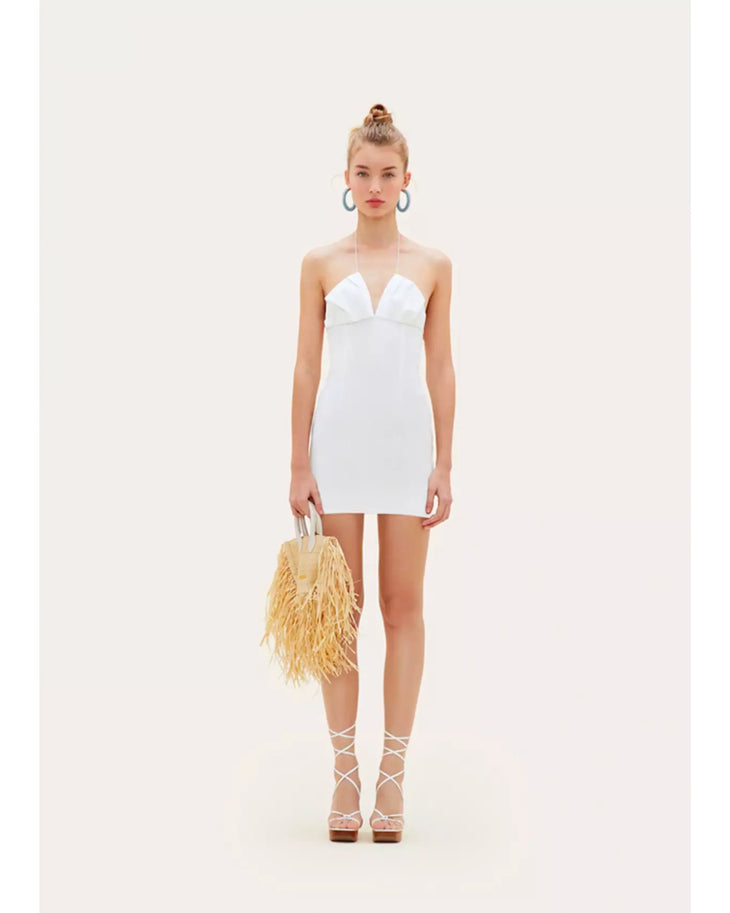 White strapless mini dress with plunging neckline styled with raffia bag and lace-up sandals — Jacquemus | Endless UAE