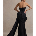 Black strapless corset maxi dress with dramatic draped side detail and wide-leg silhouette, shown from back view — Club L London | Endless UAE