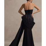Black strapless corset maxi dress with dramatic draped side detail and wide-leg silhouette, shown from back view — Club L London | Endless UAE