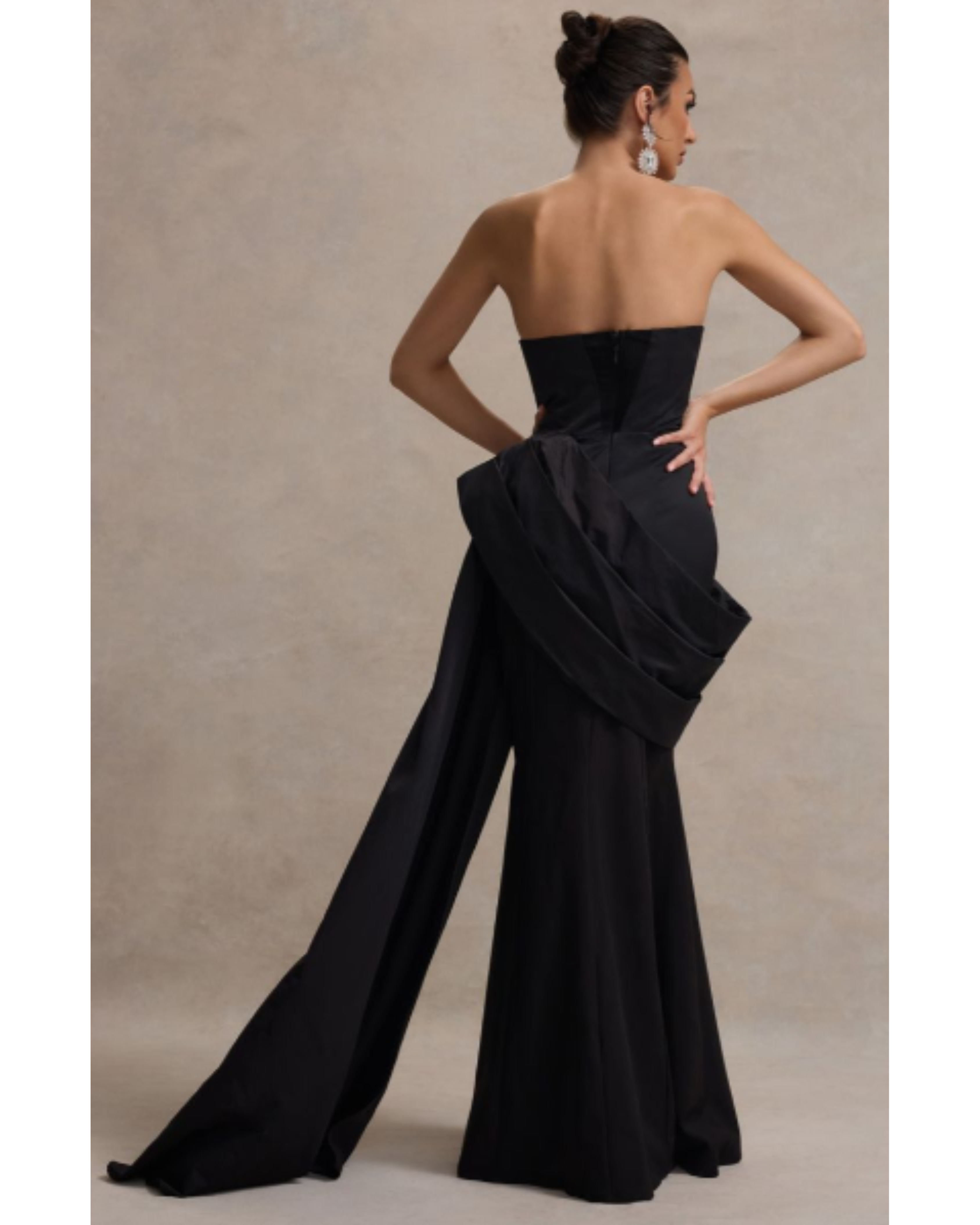 Black strapless corset maxi dress with dramatic draped side detail and wide-leg silhouette, shown from back view — Club L London | Endless UAE