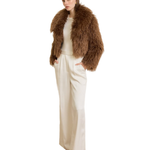 Woman wearing camel-colored fur stole jacket over cream top and pants with burgundy shoes — Madame Magdalena | Endless UAE