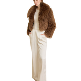 Woman wearing camel-colored fur stole jacket over cream top and pants with burgundy shoes — Madame Magdalena | Endless UAE