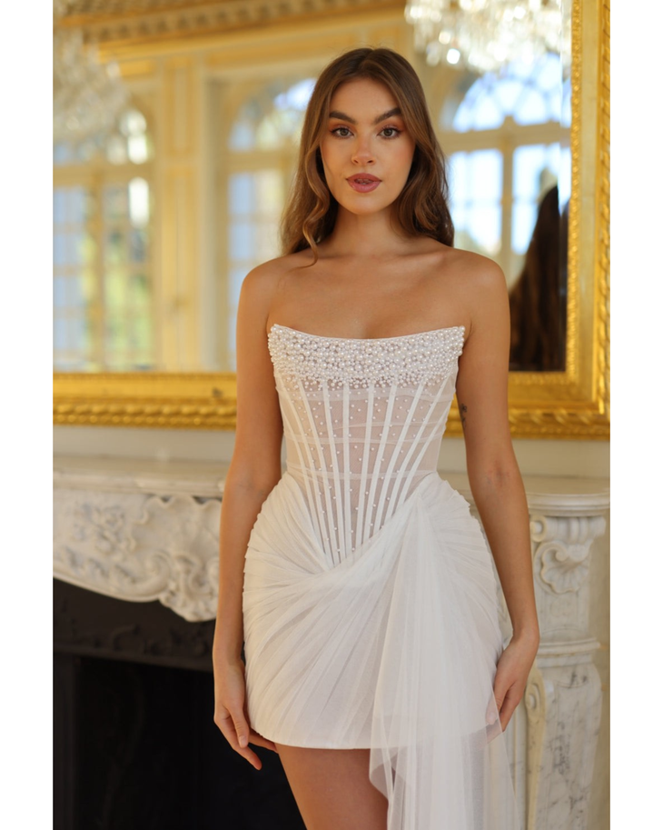 Strapless white mini dress with pearl-embellished bodice and asymmetric tulle drape detail — Rosie Etienne | Endless UAE