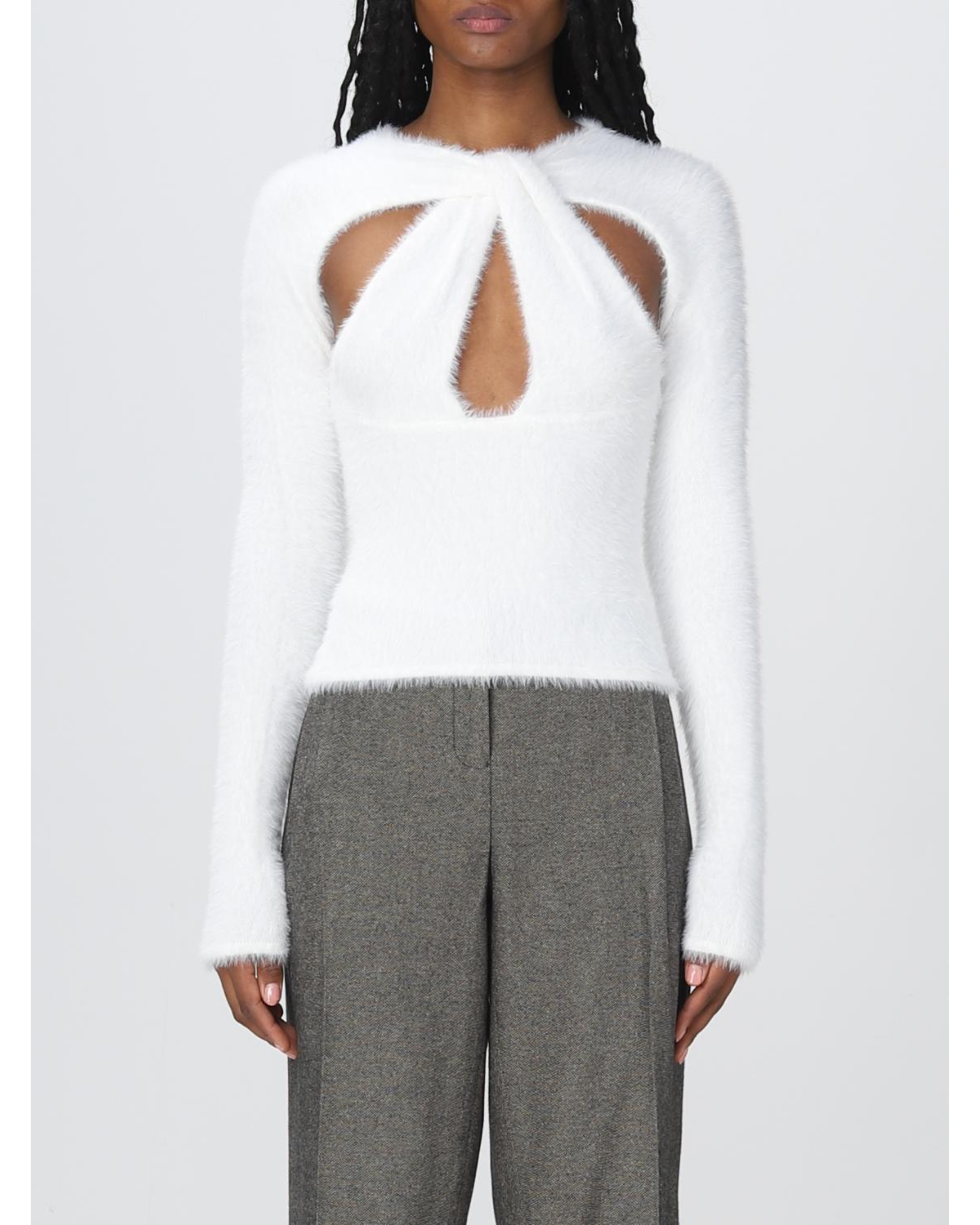 White fuzzy long-sleeve top with geometric chest cutouts paired with grey tailored trousers — Coperni | Endless UAE