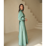 Woman in deep sea foam silky bias-cut gown with draped sleeve detail — Vasiliki | Endless UAE