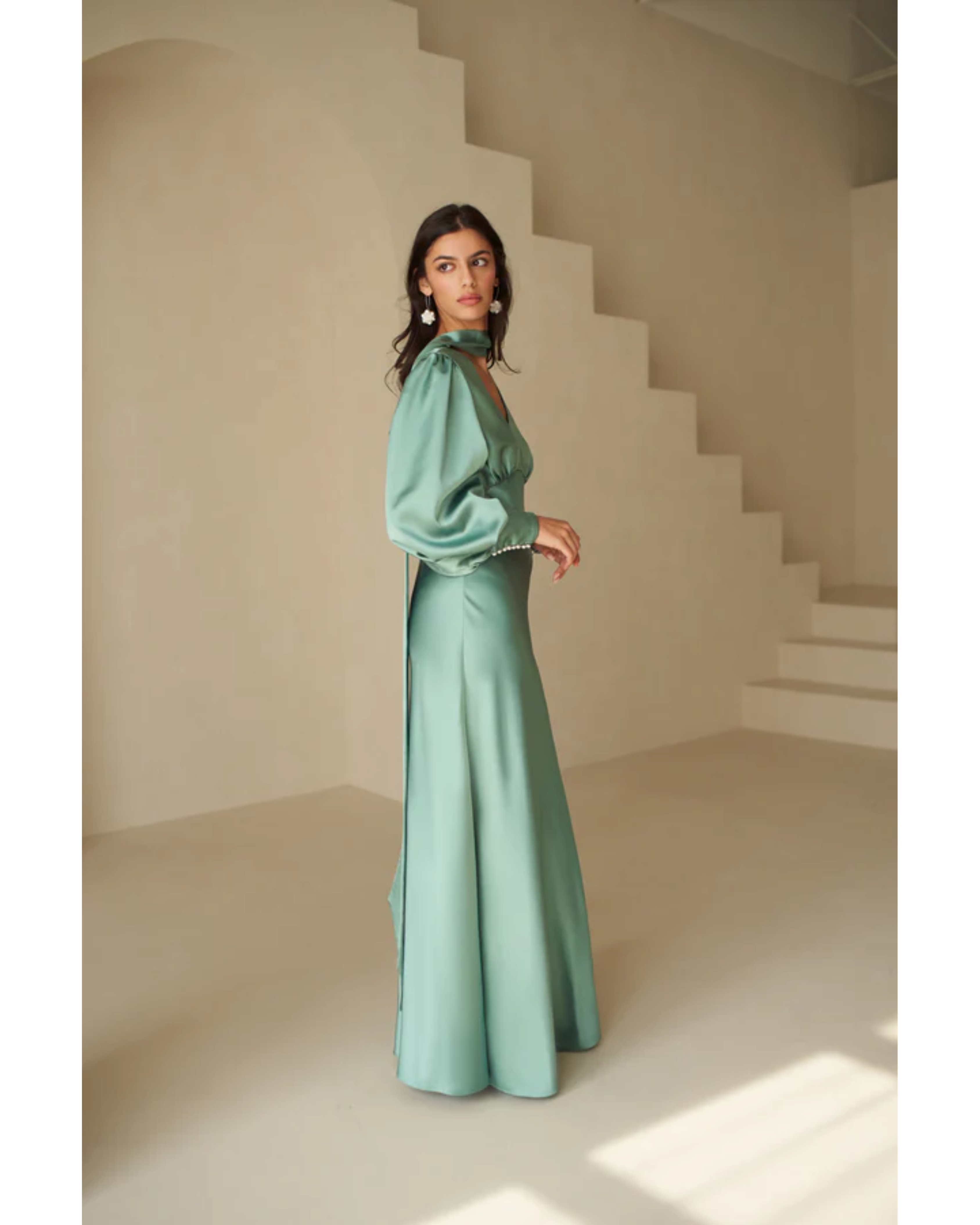 Woman in deep sea foam silky bias-cut gown with draped sleeve detail — Vasiliki | Endless UAE
