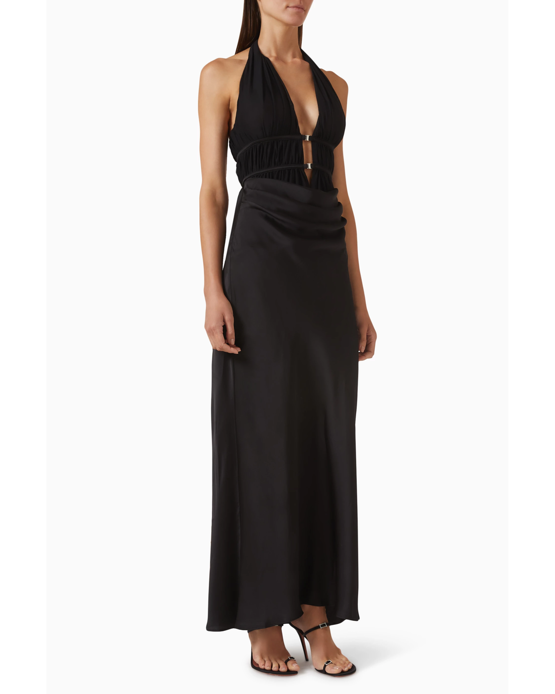 Woman wearing black halter maxi dress with ruched waist detail and silver accent — Misha | Endless UAE