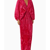 Woman wearing a fuchsia crinkled pleated oversized maxi dress with wrap front and voluminous sleeves — L'IDÉE | Endless UAE