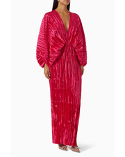 Woman wearing a fuchsia crinkled pleated oversized maxi dress with wrap front and voluminous sleeves — L'IDÉE | Endless UAE