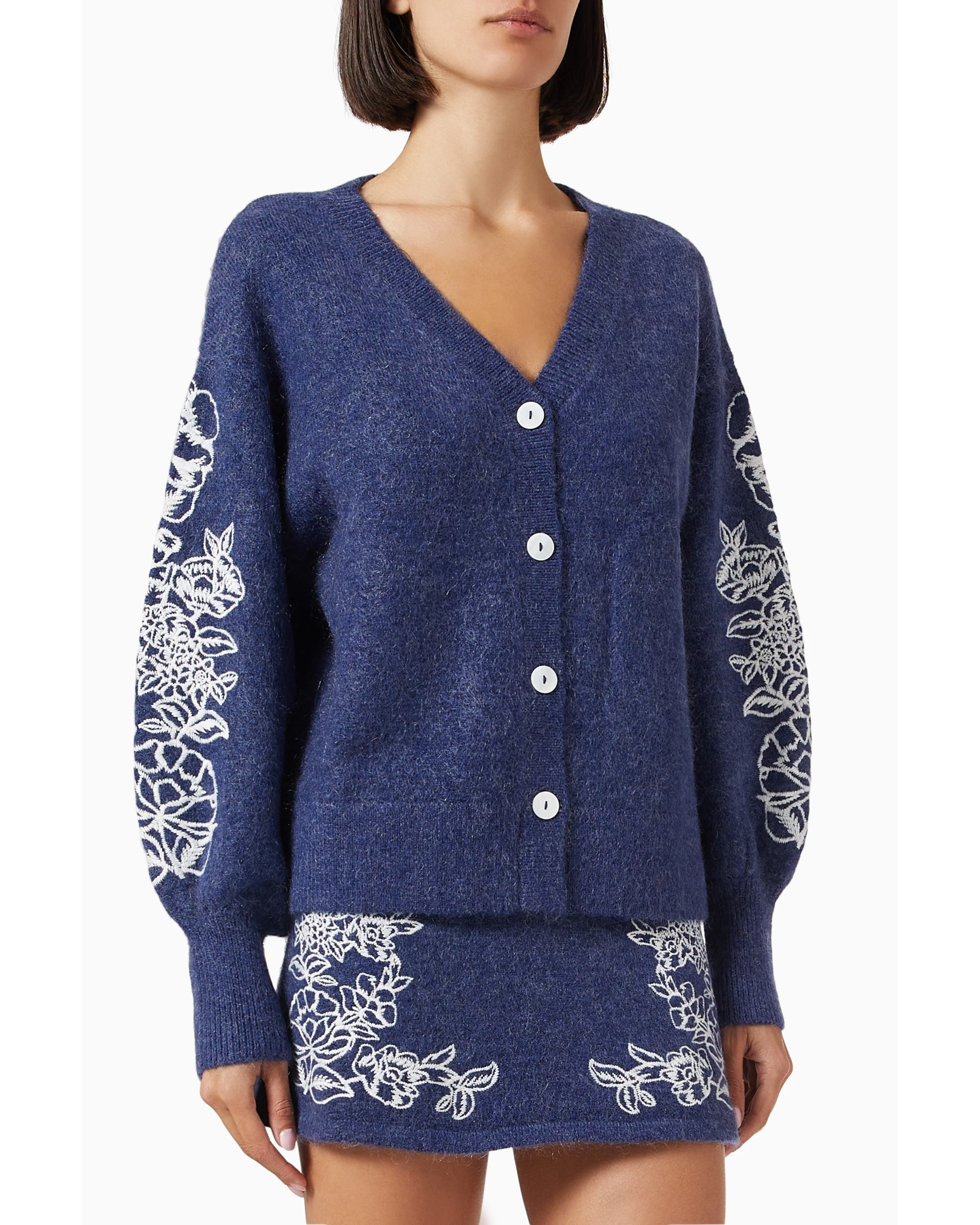 Navy blue knit cardigan with white floral embroidery on sleeves, paired with matching embroidered skirt — Aston Studio | Endless UAE