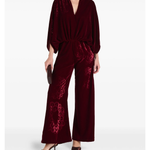Woman wearing burgundy silk velvet jumpsuit with ornamental detailing and wide legs — Themis-Z | Endless UAE