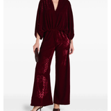 Woman wearing burgundy silk velvet jumpsuit with ornamental detailing and wide legs — Themis-Z | Endless UAE