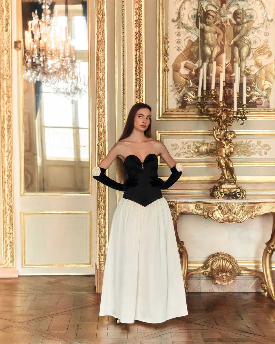 Woman wearing black and white off-shoulder Parisienne Maxi Dress in ornate palace room — Lichi | Endless UAE