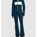 Woman wearing navy and white colorblocked ski jumpsuit with belt and black boots — Cordova | Endless UAE