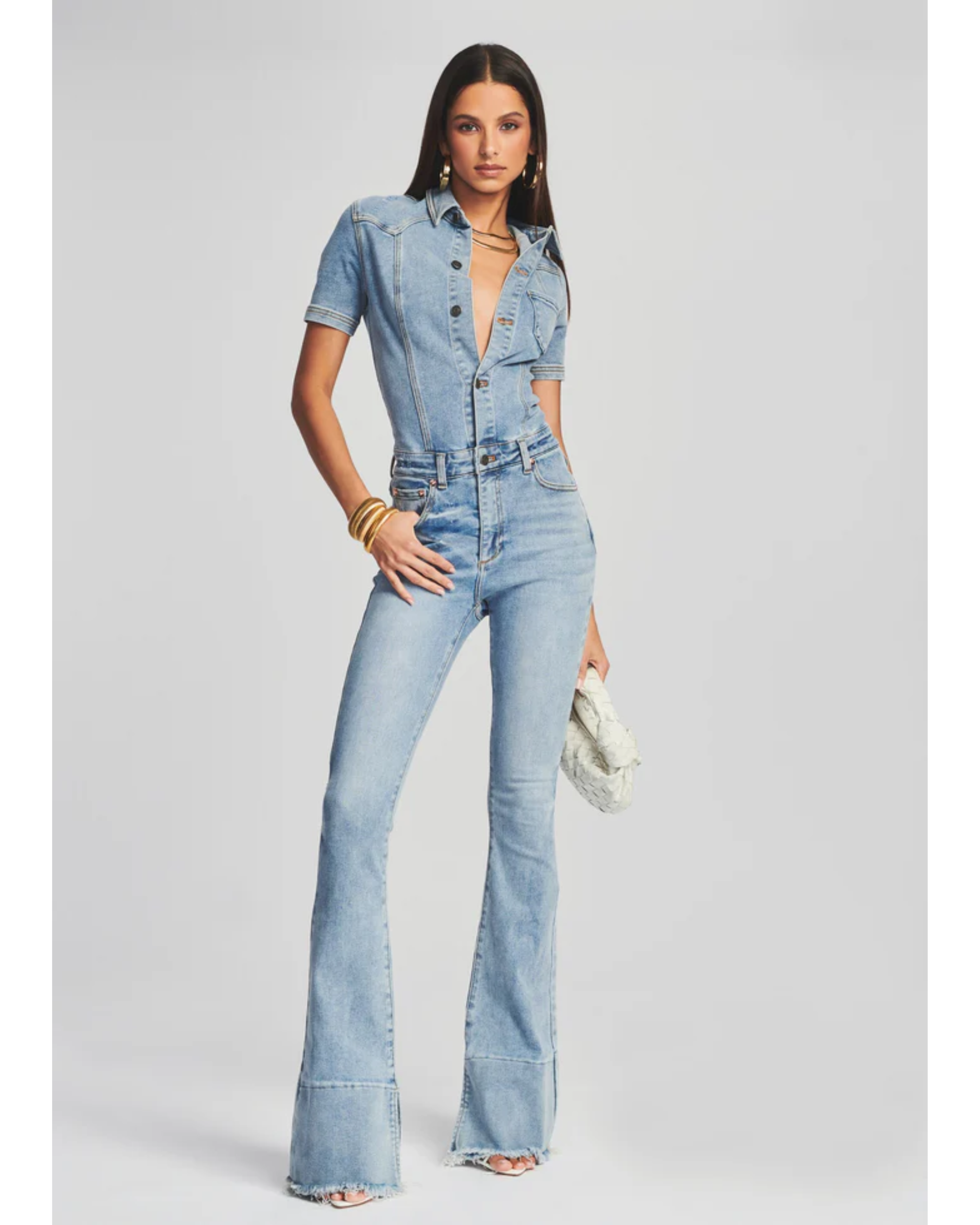 Woman wearing light blue denim Fallon Jumpsuit with short sleeves and flared legs — SER.O.YA | Endless UAE