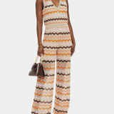 Woman wearing a colorful striped cotton jumpsuit with orange, brown and cream zigzag pattern — Missoni | Endless UAE