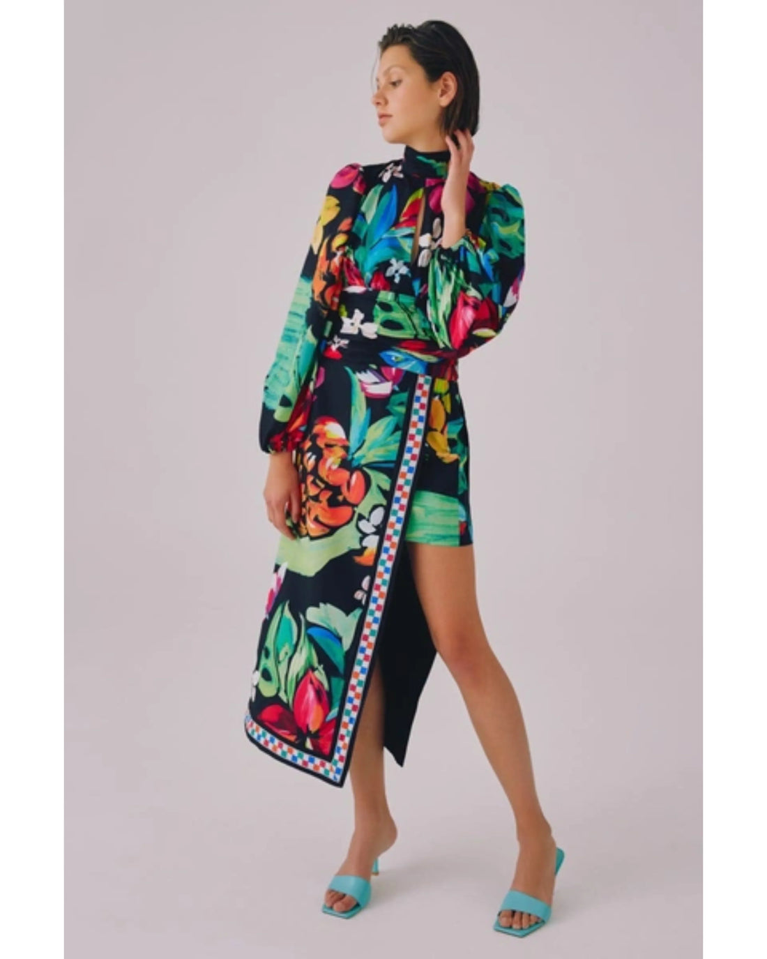 Woman wearing vibrant floral print wrap dress with puffed sleeves and turquoise slides — C/MEO Collective | Endless UAE