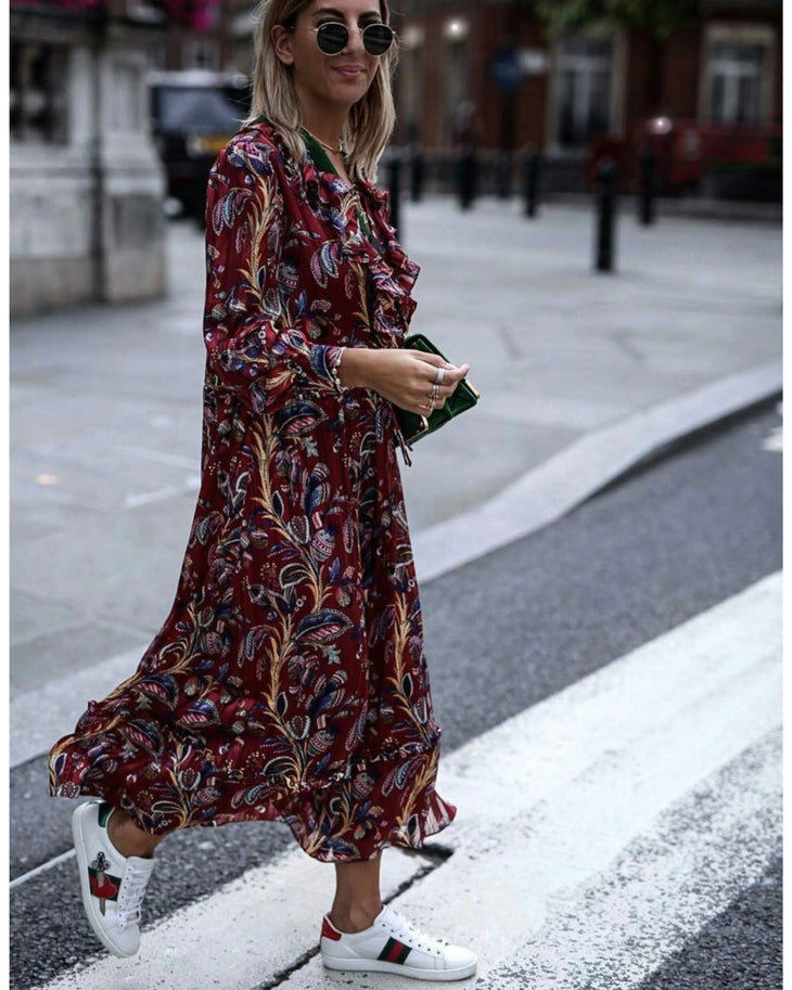 Woman wearing burgundy paisley maxi dress with white sneakers and sunglasses in urban setting — & Other Stories | Endless UAE