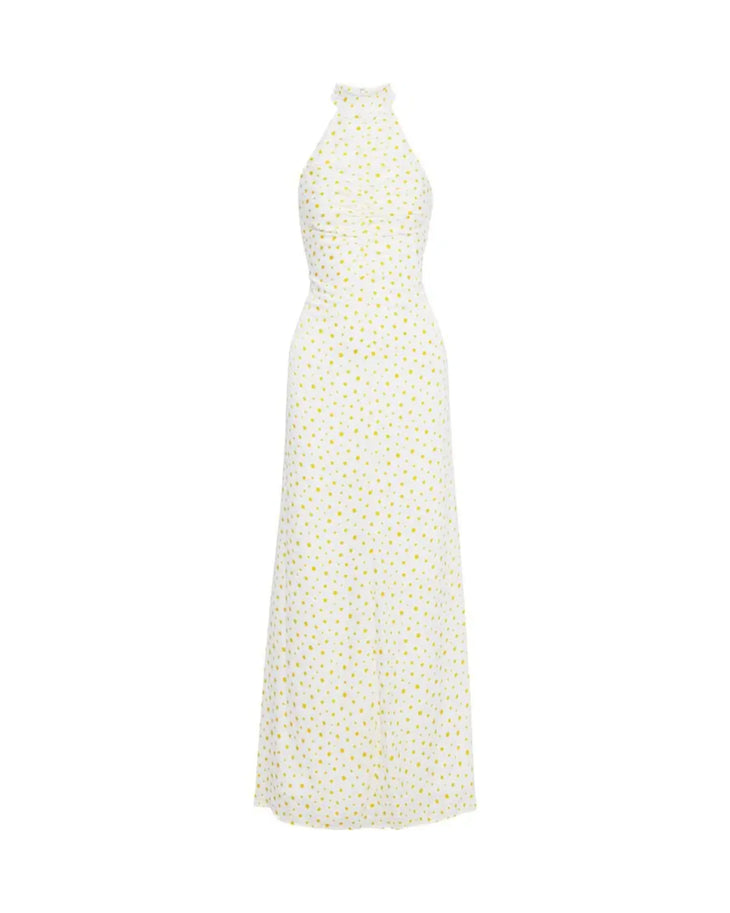 Woman wearing white Coastal Daisy Maxi Dress with yellow floral print and halter neckline — Staud | Endless UAE