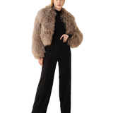 Woman wearing mocha fuzzy cropped jacket over black turtleneck and wide-leg trousers — Madame Magdalena | Endless UAE