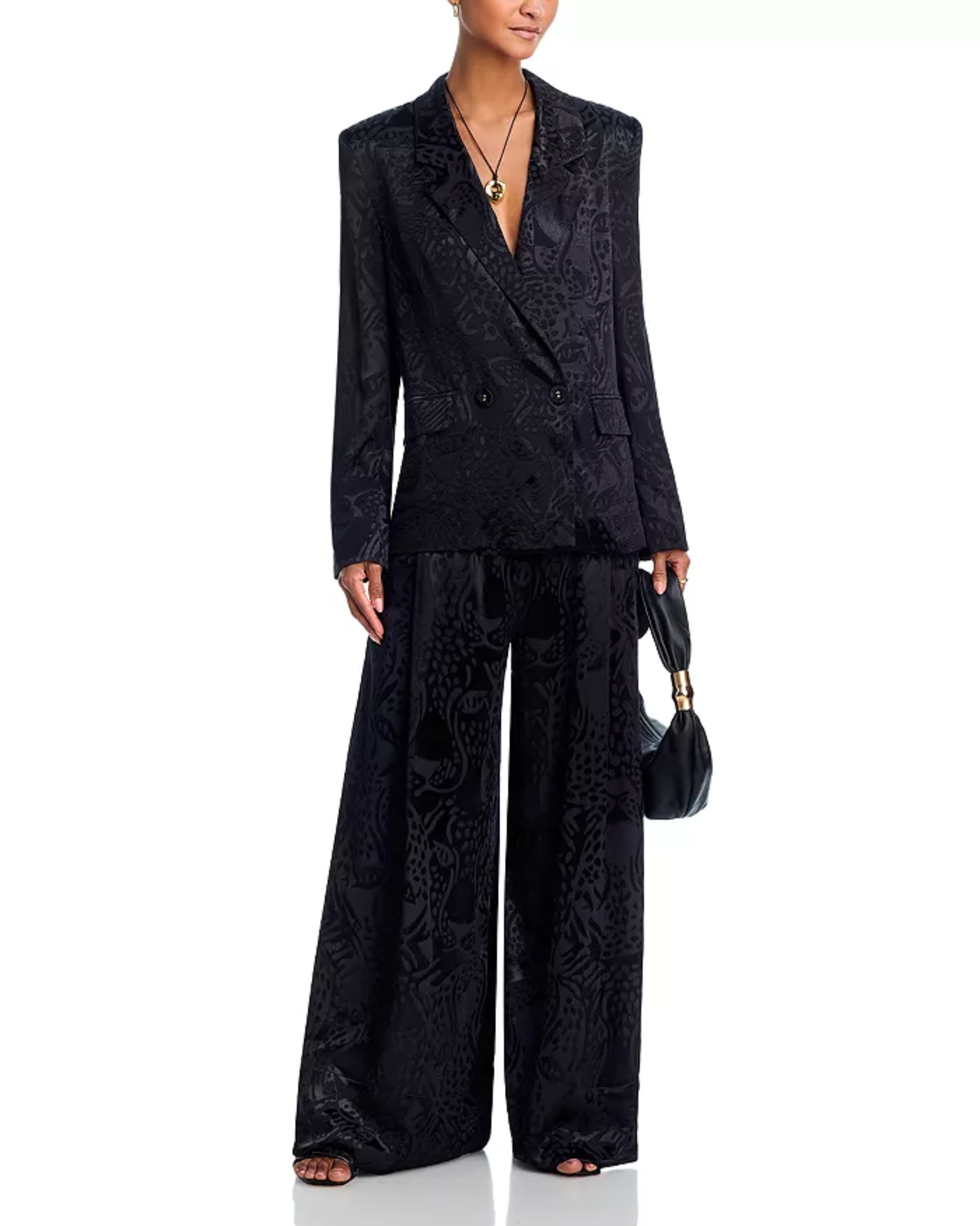 Woman wearing black leopard jacquard blazer and matching wide leg pants with accessories — Farm Rio | Endless UAE
