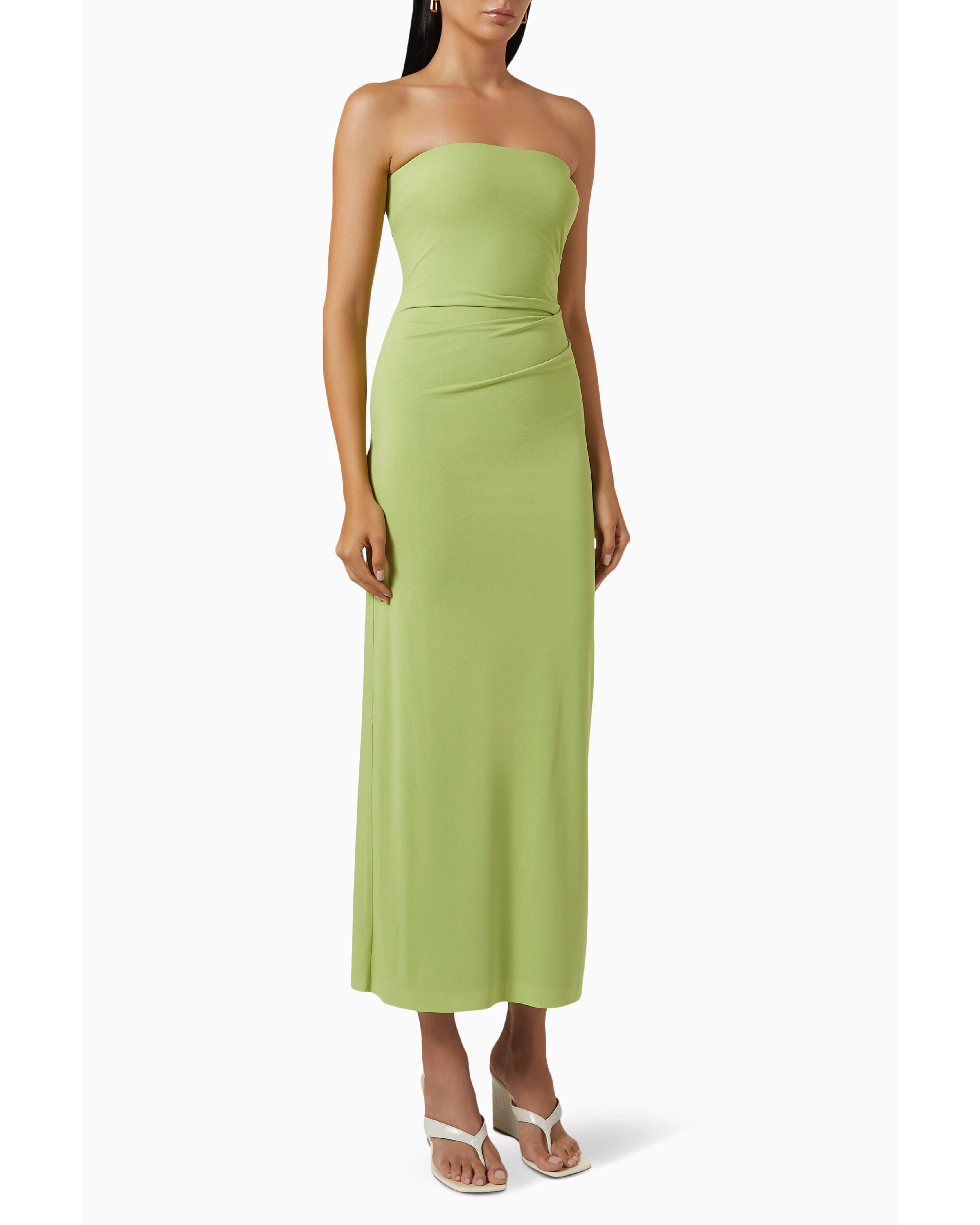 Woman wearing lime green strapless midi dress with ruched waist and white sandals — Bec & Bridge | Endless UAE