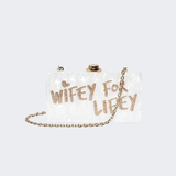Wifey For Lifey clear clutch bag with gold glitter text and gold-tone hardware — Sophia Webster | Endless UAE