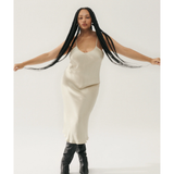 Woman wearing cream spaghetti strap slip dress with black strappy heels — Silk Laundry | Endless UAE