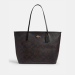 Black leather tote bag with dual handles and Coach branding — Coach | Endless UAE