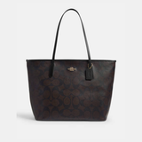 Black leather tote bag with dual handles and Coach branding — Coach | Endless UAE