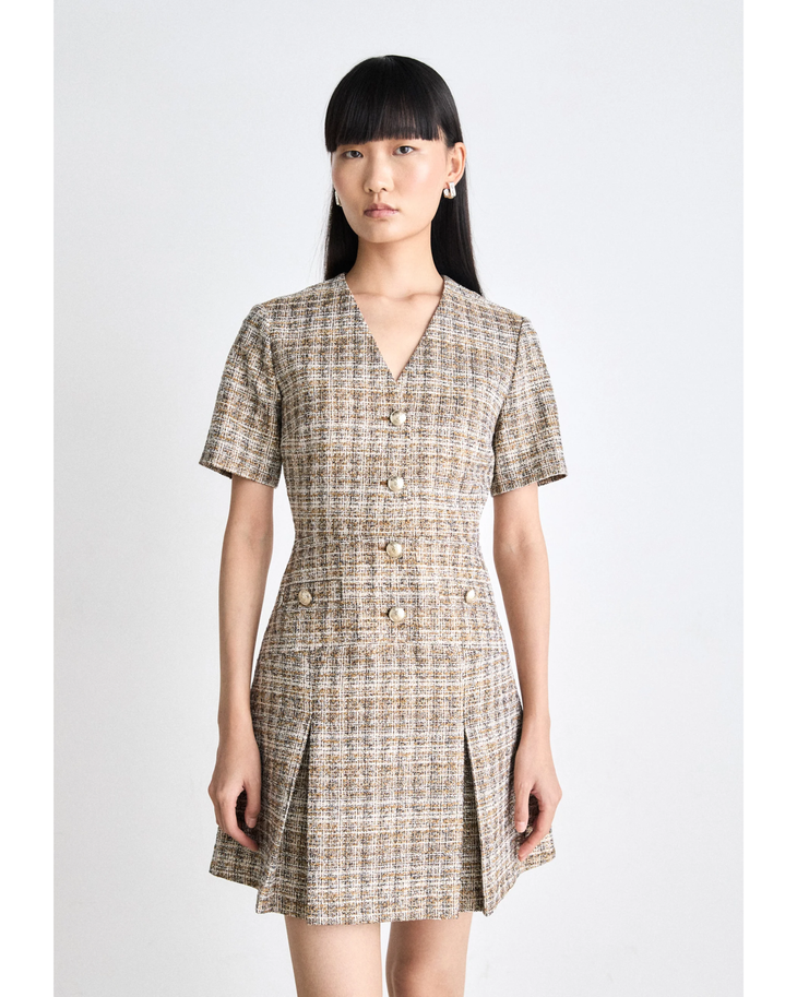 Woman wearing beige and brown checked tweed mini dress with v-neck, short sleeves and gold button details — Maje | Endless UAE