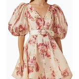 Woman wearing a cream linen mini dress with pink floral print, puff sleeves, and belted waist — ZIMMERMANN | Endless UAE