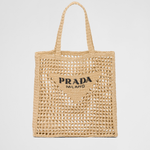 Natural raffia tote bag with open-weave crochet design, triangle logo patch, and braided handles — Prada | Endless UAE