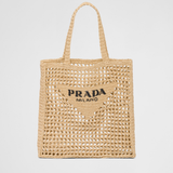 Natural raffia tote bag with open-weave crochet design, triangle logo patch, and braided handles — Prada | Endless UAE