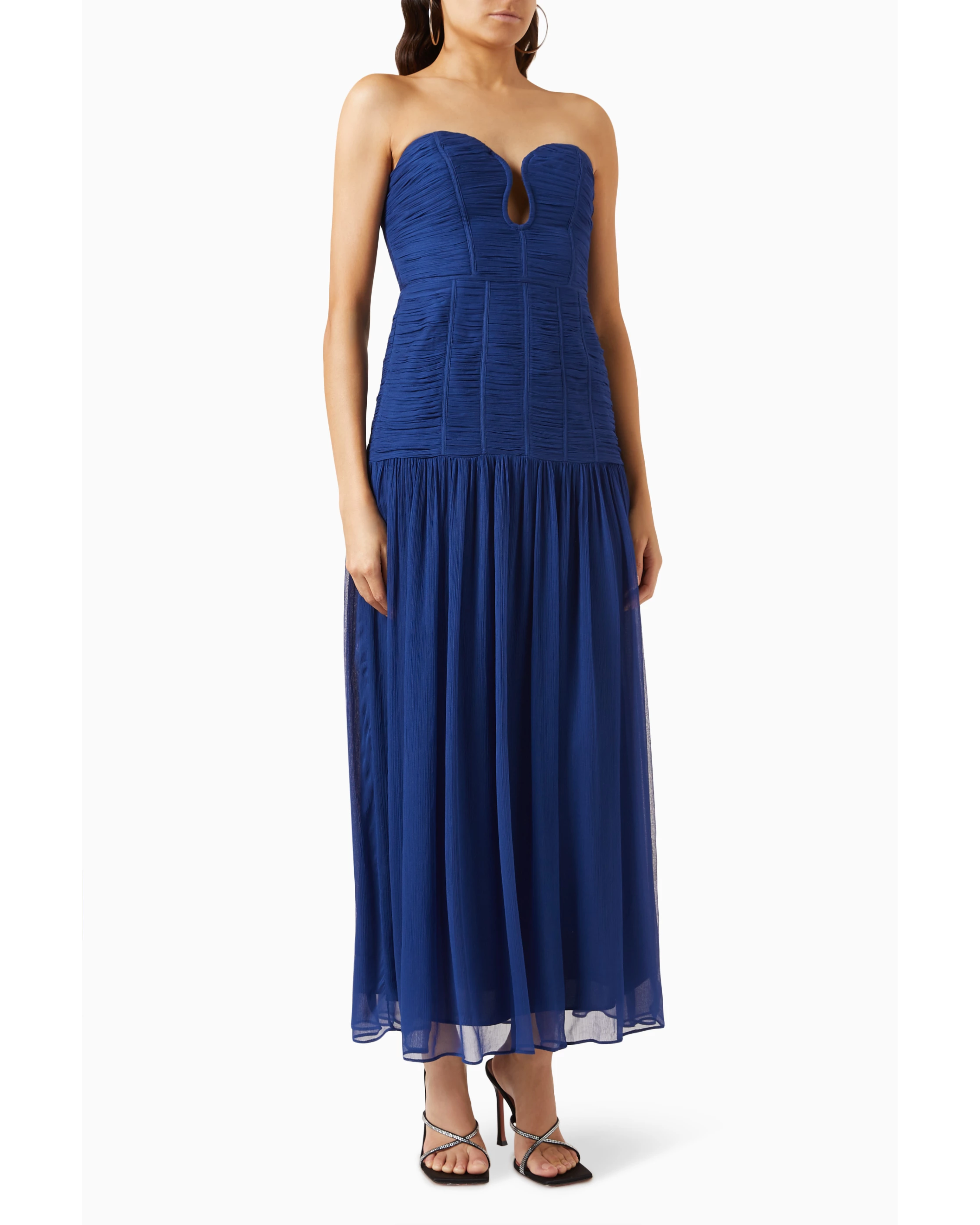 Woman wearing Isola Strapless Ruched Midi Dress in blue with black sandals — Shona Joy | Endless UAE