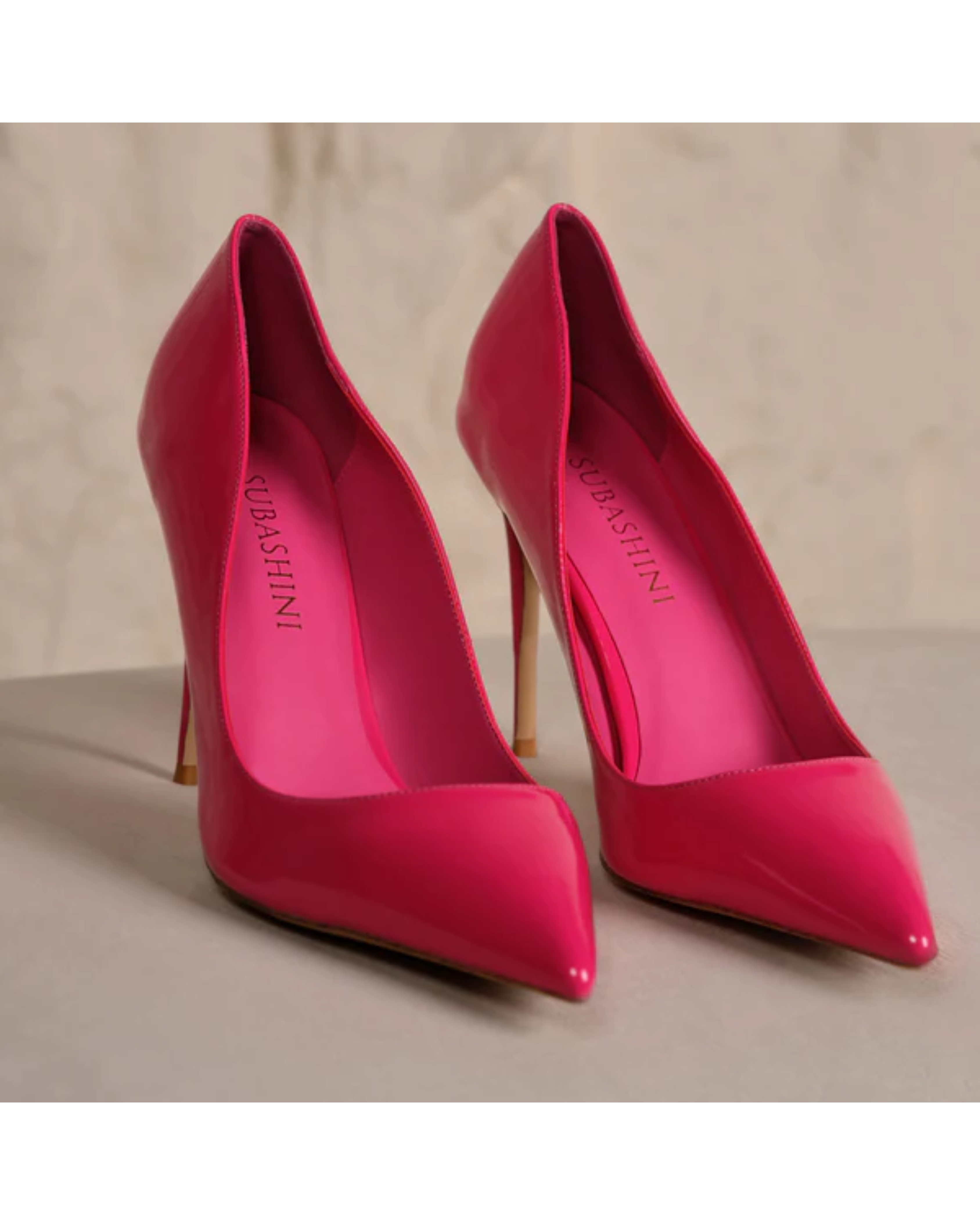 Hot pink pointed-toe stiletto heels with high heels on beige surface — Subashini Heels | Endless UAE