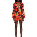 Woman wearing vibrant red and orange strawberry print blazer dress with green handbag — Louisa Ballou | Endless UAE