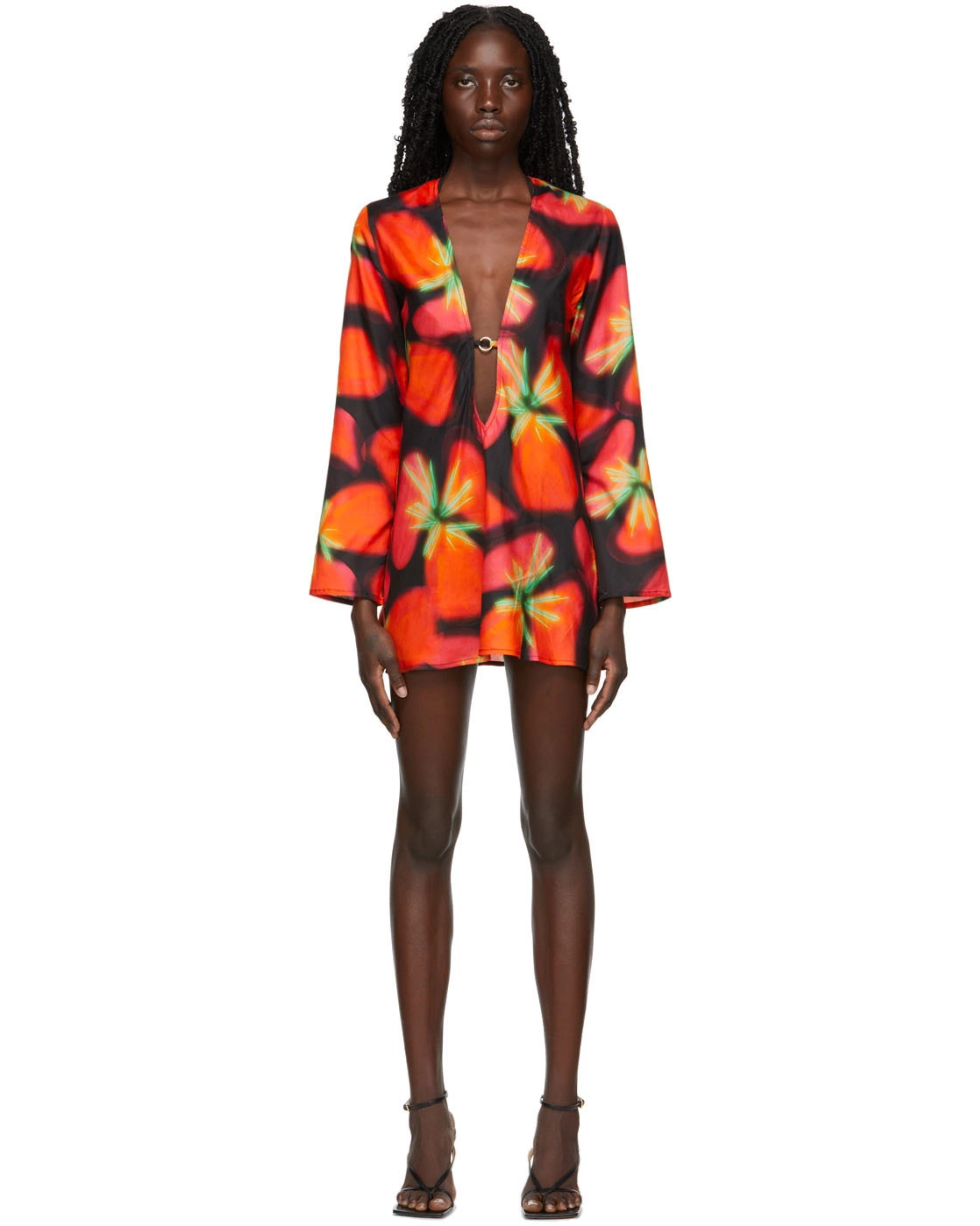 Woman wearing vibrant red and orange strawberry print blazer dress with green handbag — Louisa Ballou | Endless UAE