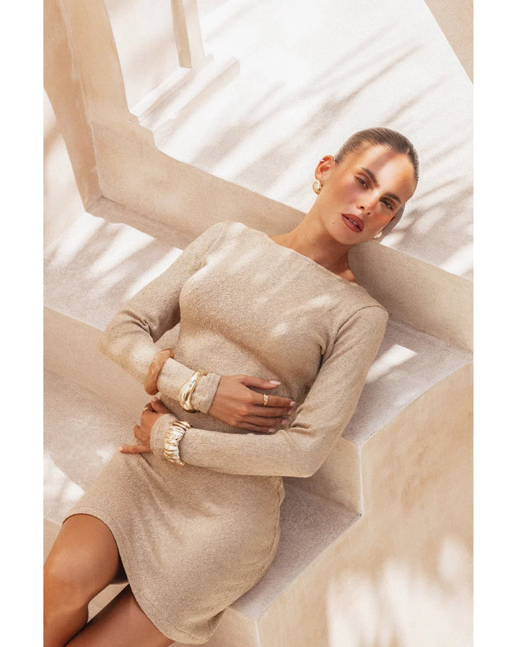 Pregnant woman wearing beige long-sleeve Yasmin Dress with ruched cuffs — Miharo | Endless UAE