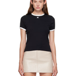 Woman wearing black and white contrast t-shirt with cream skirt — Courrèges | Endless UAE
