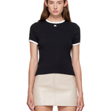 Woman wearing black and white contrast t-shirt with cream skirt — Courrèges | Endless UAE