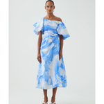 Woman wearing blue and white abstract print Cadence Ruched Midi Dress with puffed sleeves and white slides — Aje | Endless UAE