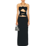 Black maxi dress with cutout waist detail and tie accents, paired with zebra print bag — Mygel Coronel | Endless UAE