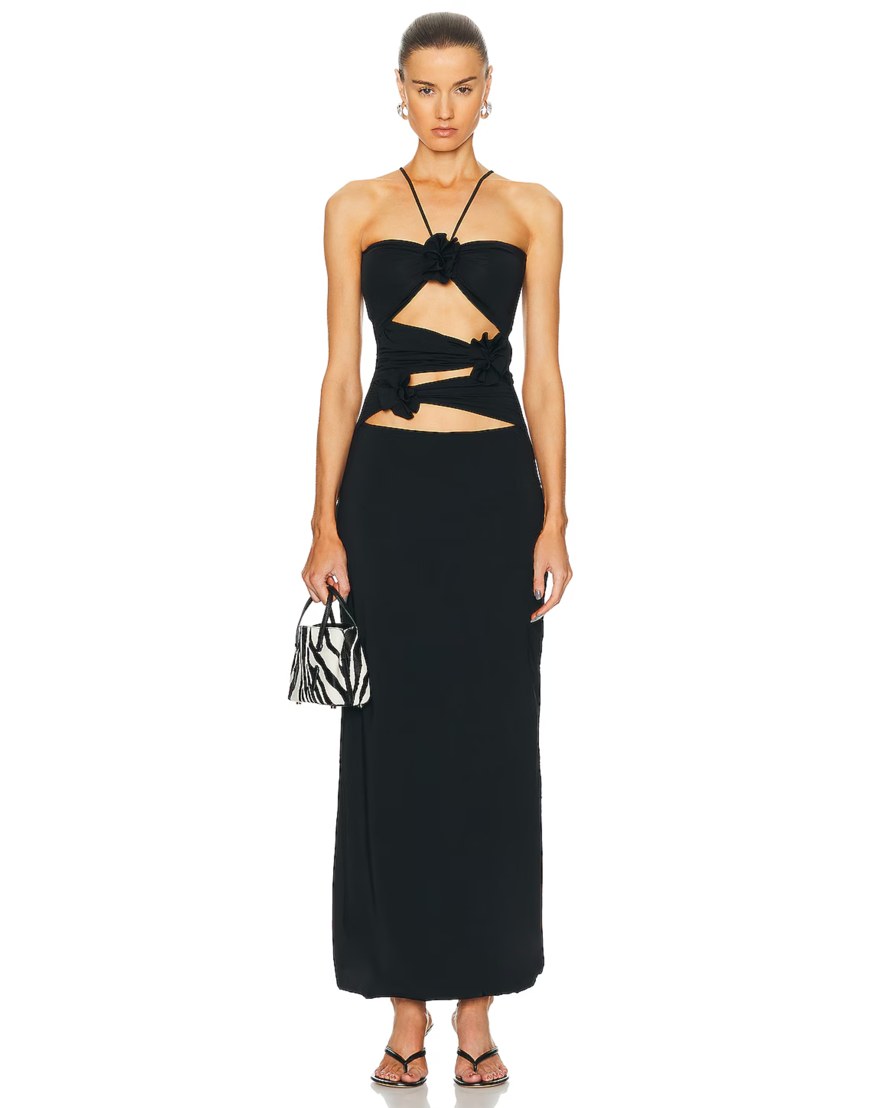 Black maxi dress with cutout waist detail and tie accents, paired with zebra print bag — Mygel Coronel | Endless UAE