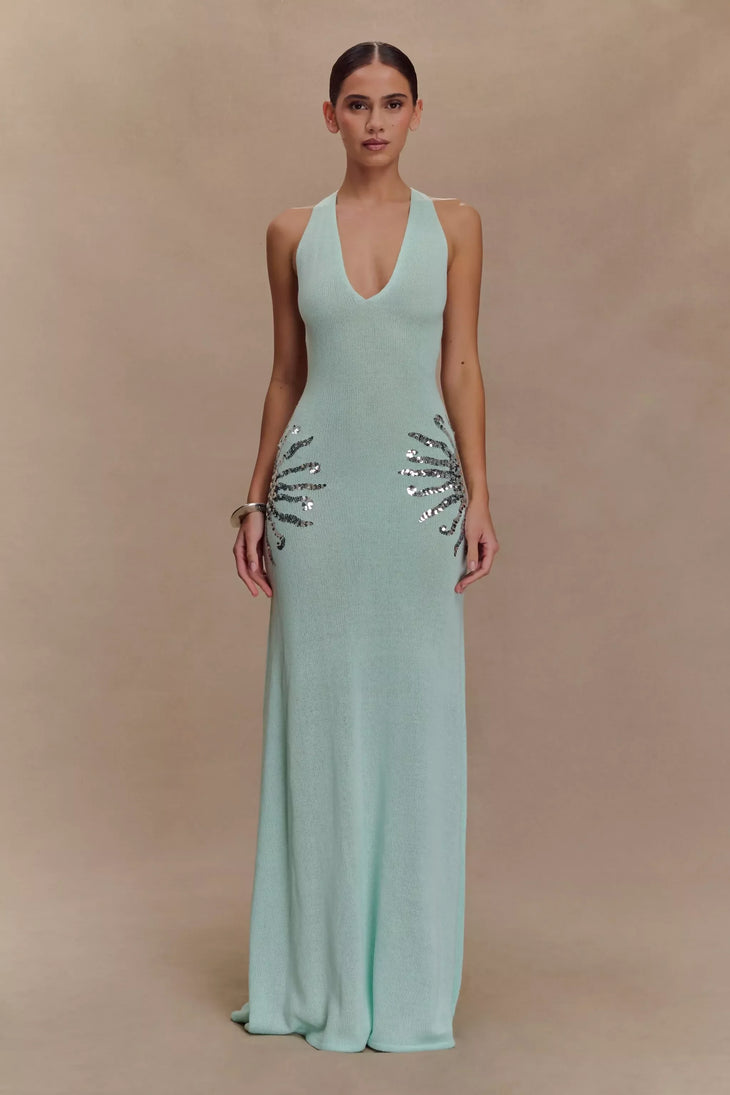 Woman wearing floor-length lagoon blue knit maxi dress with plunging neckline and sequin hip details — Meshki | Endless UAE
